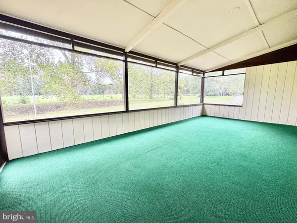 an empty room with large windows