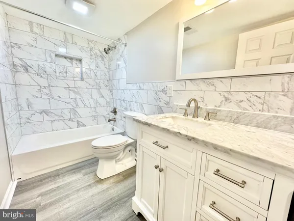 a bathroom with a sink toilet a shower and bathtub