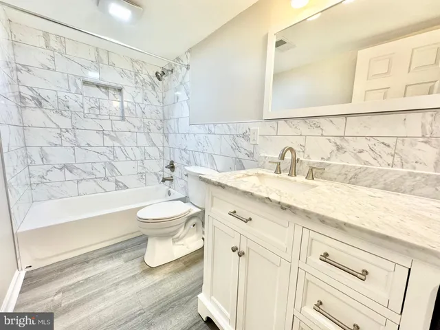 a bathroom with a sink toilet a shower and bathtub