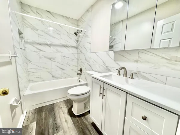 a bathroom with a sink toilet a mirror and shower