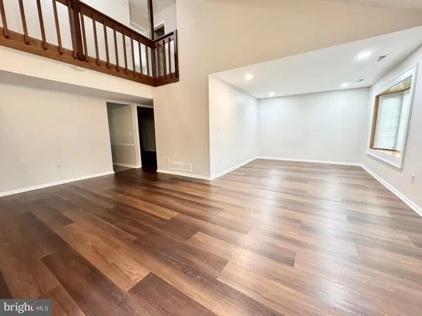 a view of an entryway with wooden floor