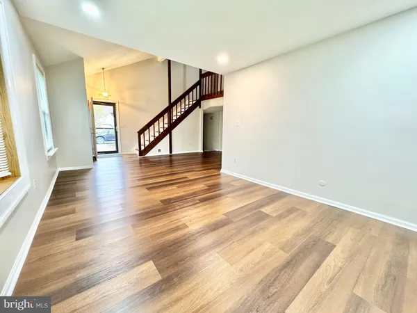 a view of an entryway with wooden floor