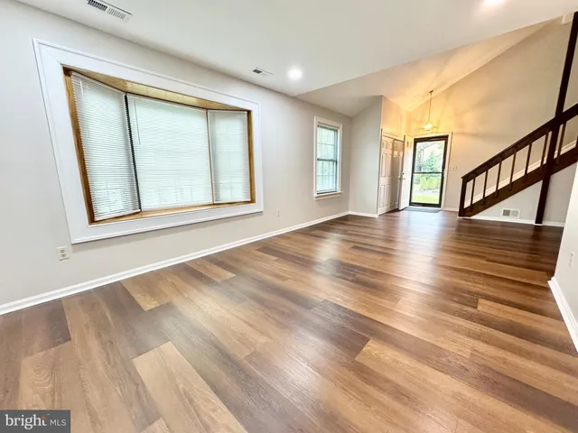 a view of an entryway with wooden floor
