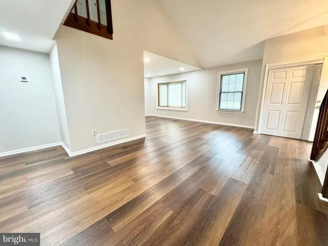 a view of a room with wooden floor and window