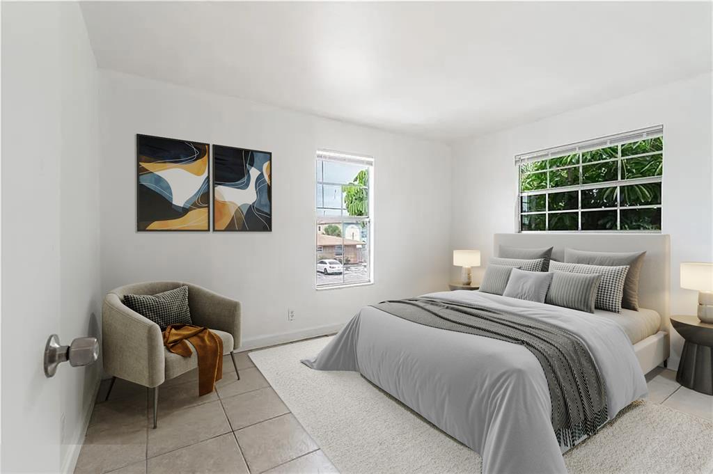 312 Southeast 10th Avenue, Unit C Pompano Beach, FL 33060 - Photo 15 of 23 a bedroom with a bed and a window