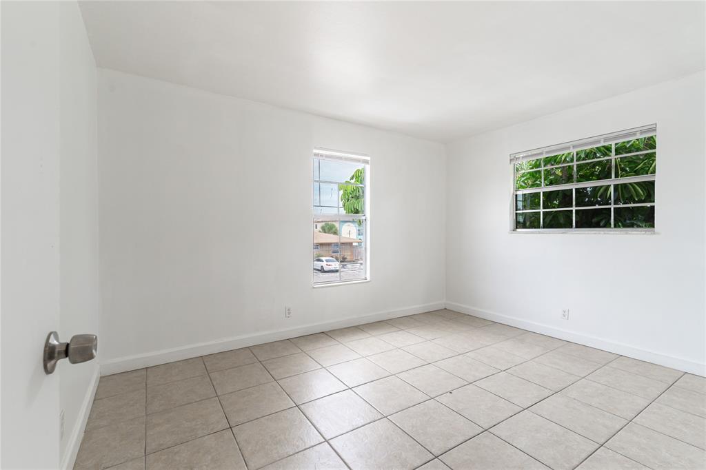 312 Southeast 10th Avenue, Unit C Pompano Beach, FL 33060 - Photo 16 of 23 an empty room with windows