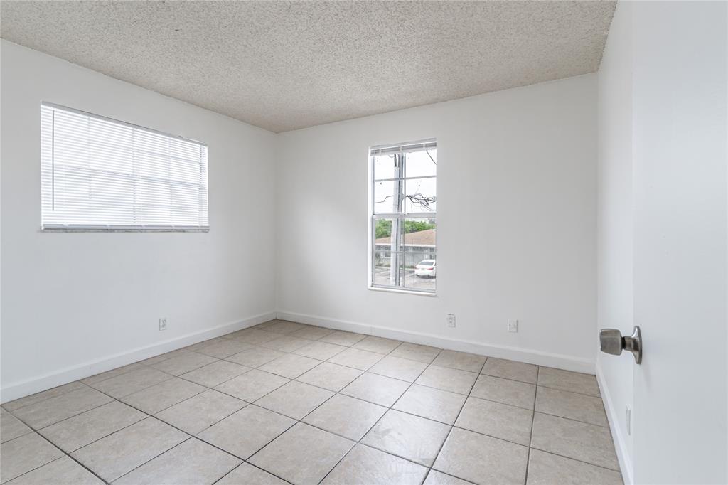 312 Southeast 10th Avenue, Unit C Pompano Beach, FL 33060 - Photo 17 of 23 an empty room with windows