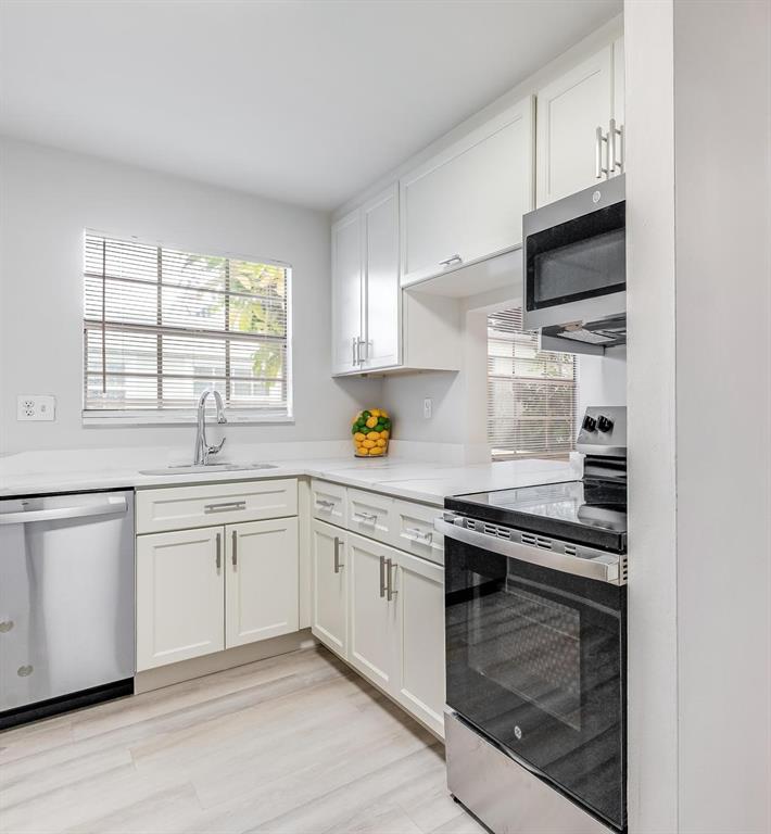 312 Southeast 10th Avenue, Unit C Pompano Beach, FL 33060 - Photo 3 of 23 a kitchen with granite countertop cabinets stainless steel appliances and window