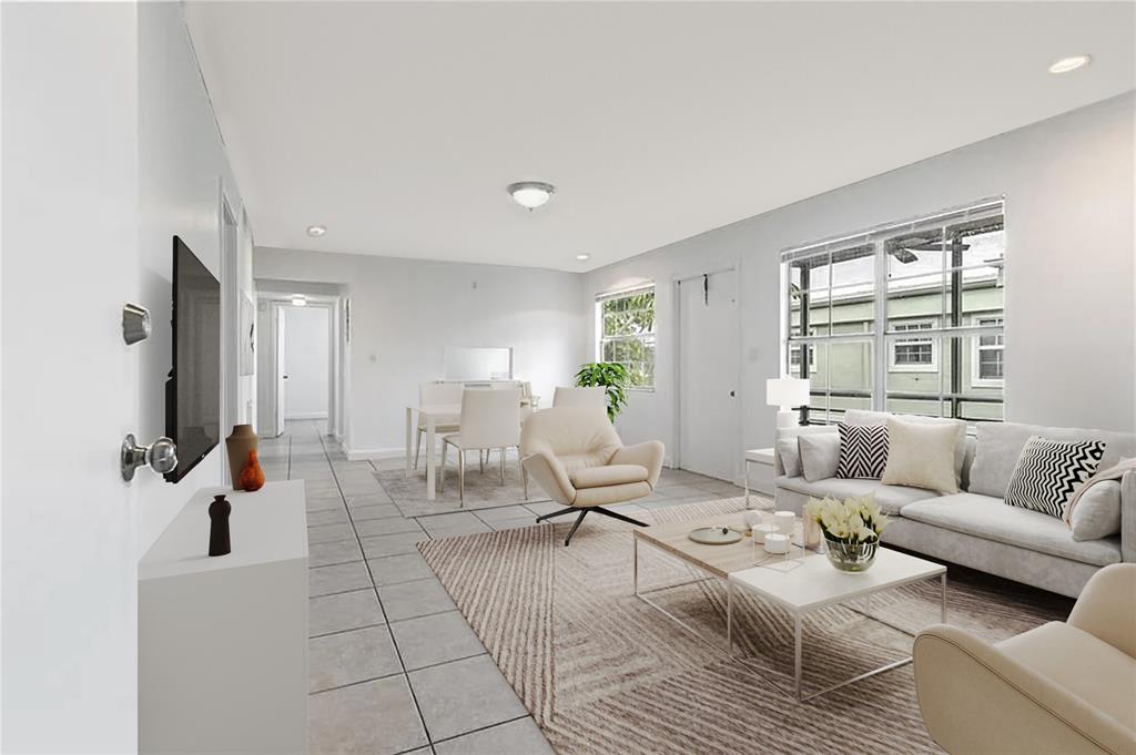 312 Southeast 10th Avenue, Unit C Pompano Beach, FL 33060 - Photo 4 of 23 a living room with furniture large window and a table