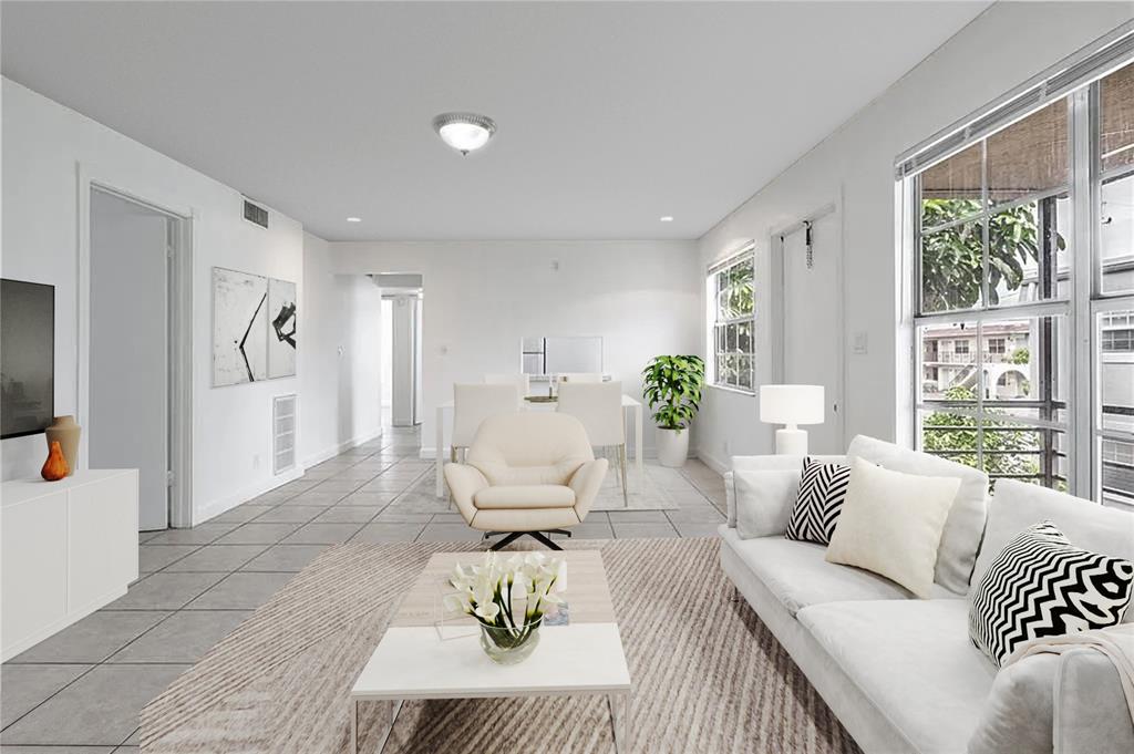 312 Southeast 10th Avenue, Unit C Pompano Beach, FL 33060 - Photo 6 of 23 a living room with furniture and a large window