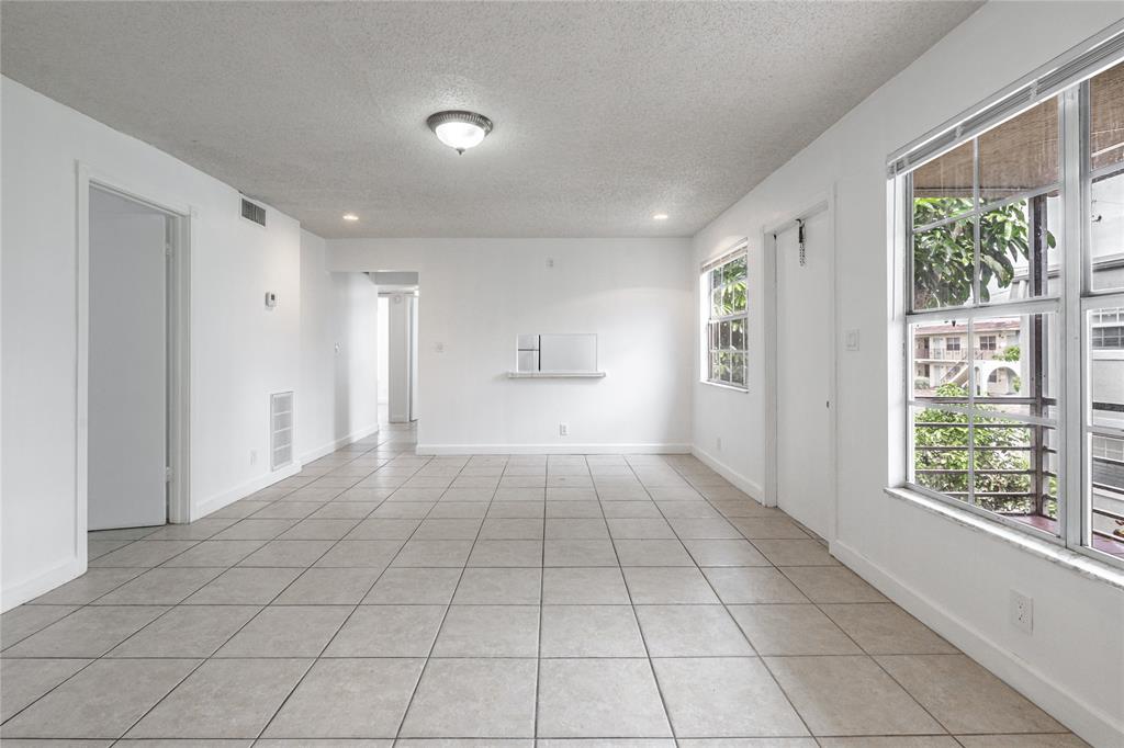 312 Southeast 10th Avenue, Unit C Pompano Beach, FL 33060 - Photo 7 of 23 a view of an empty room with a window