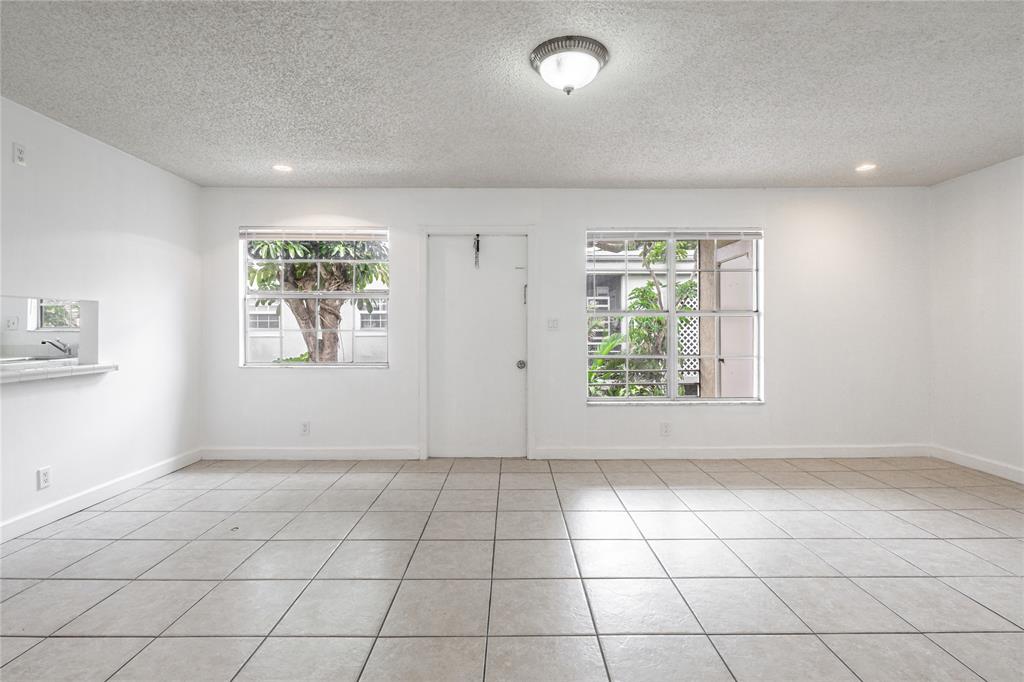 312 Southeast 10th Avenue, Unit C Pompano Beach, FL 33060 - Photo 8 of 23 an empty room with windows