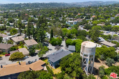 an aerial view of a house with a yard