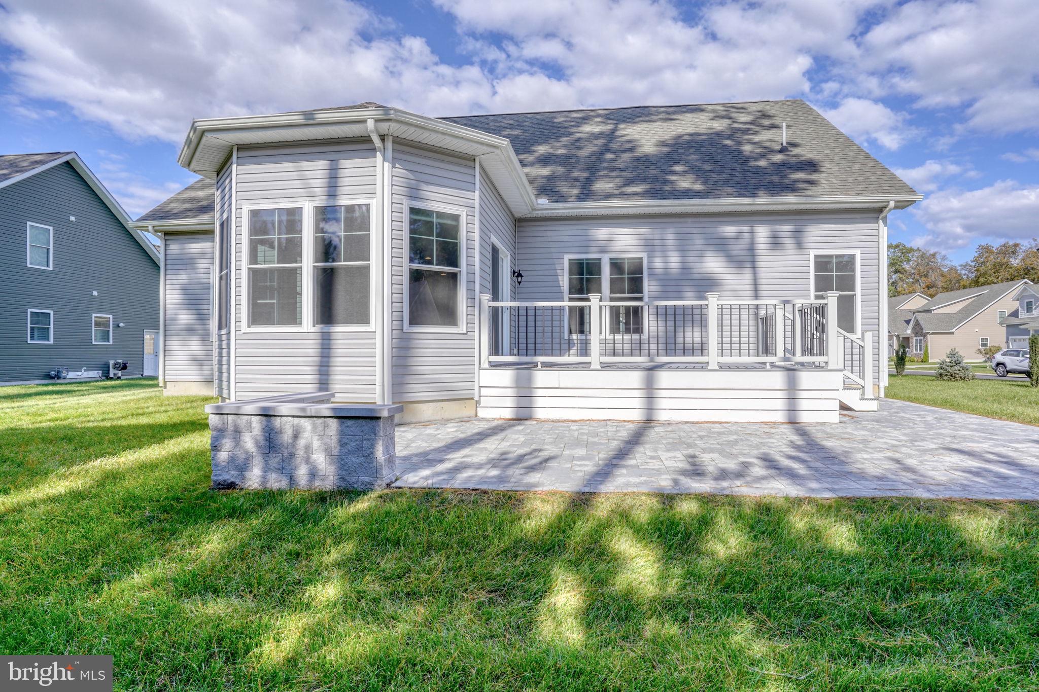 18822 Melville Way Georgetown, DE 19947 - Photo 12 of 24 a front view of a house with a yard