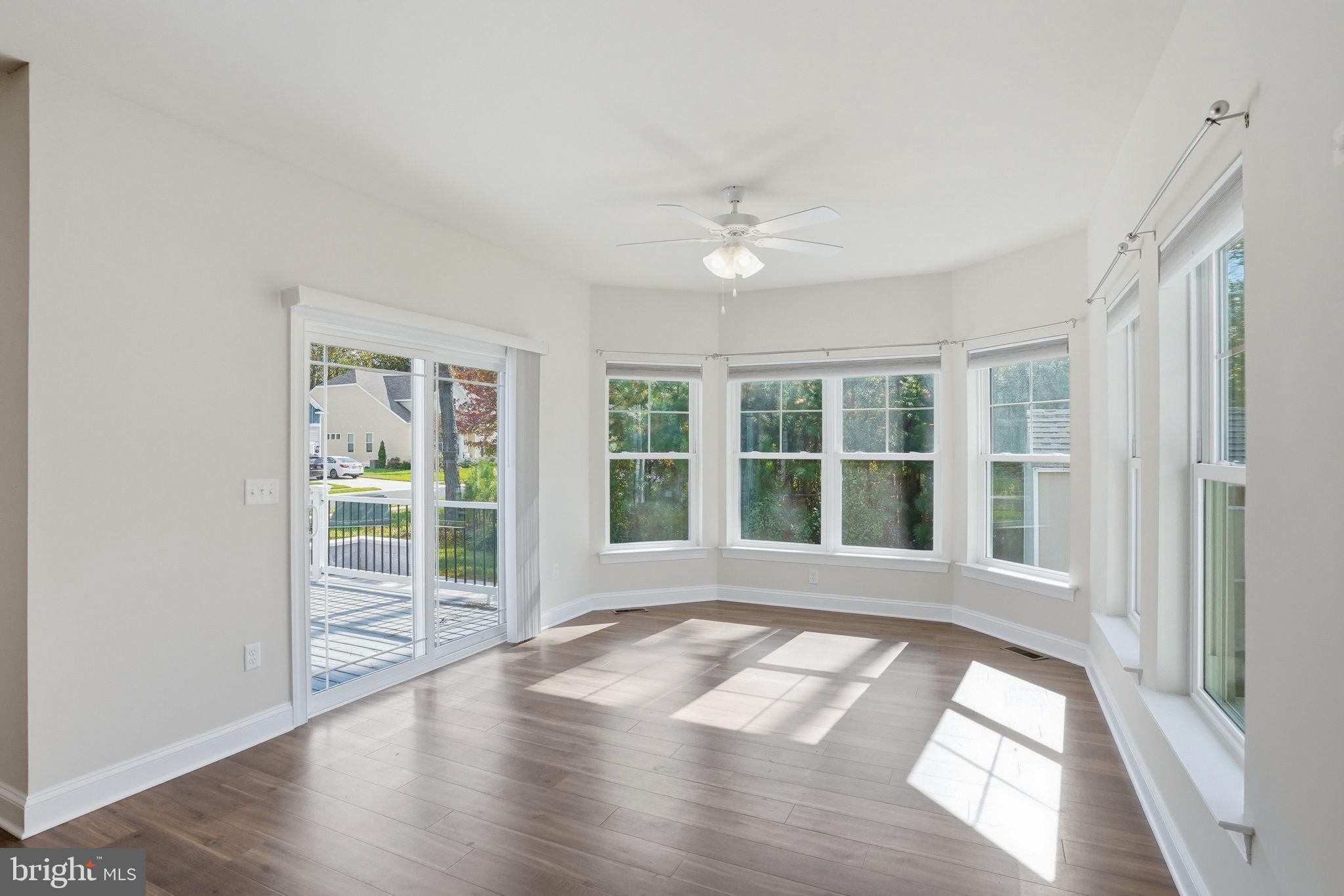 18822 Melville Way Georgetown, DE 19947 - Photo 15 of 24 a view of an empty room with wooden floor and a window