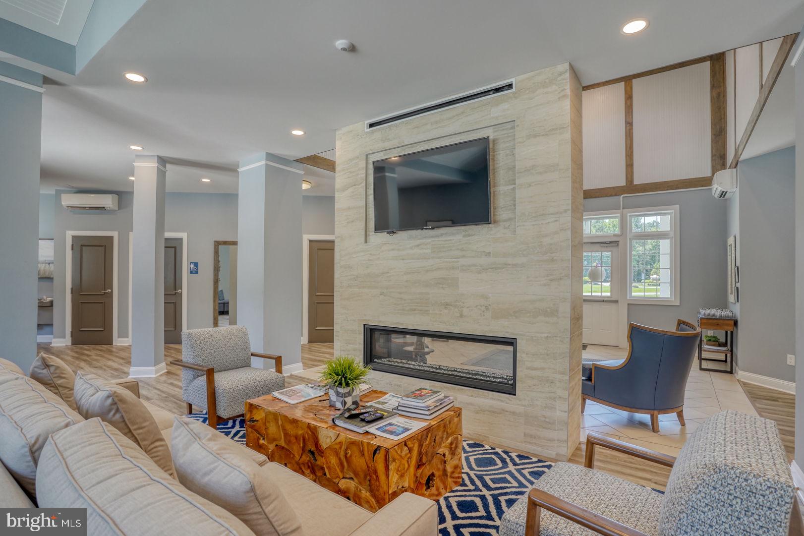 18822 Melville Way Georgetown, DE 19947 - Photo 19 of 24 a living room with furniture and a fireplace