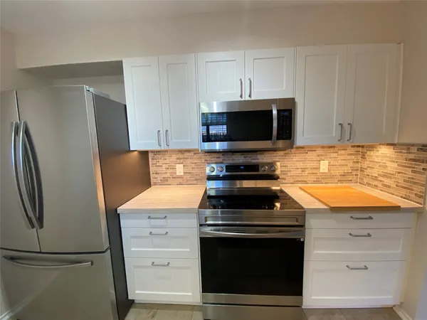 a kitchen with a stove microwave and refrigerator