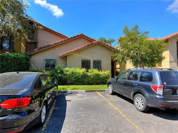 a view of a car parked in front of a house
