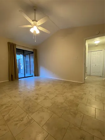 an empty room with windows and entrance