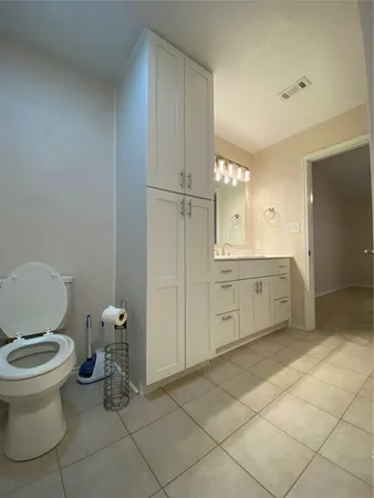 a room with a cabinets and stainless steel appliances