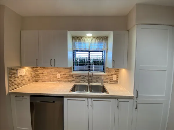a kitchen with a sink and a window