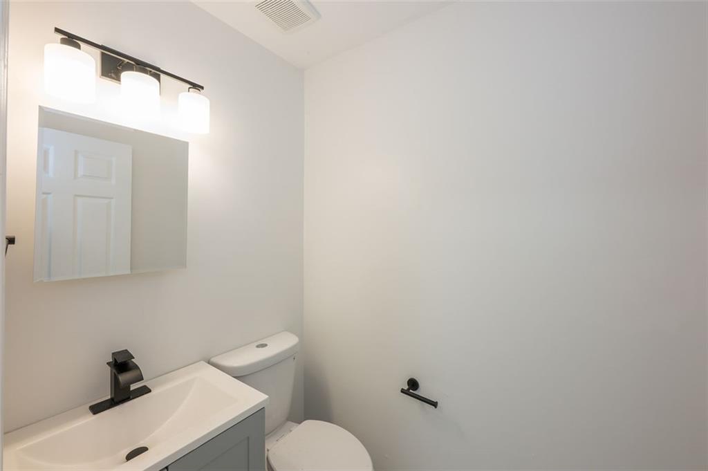 2027 Lois Place Northwest, Unit A Atlanta, GA 30318 - Photo 12 of 23 a bathroom with a sink mirror and toilet