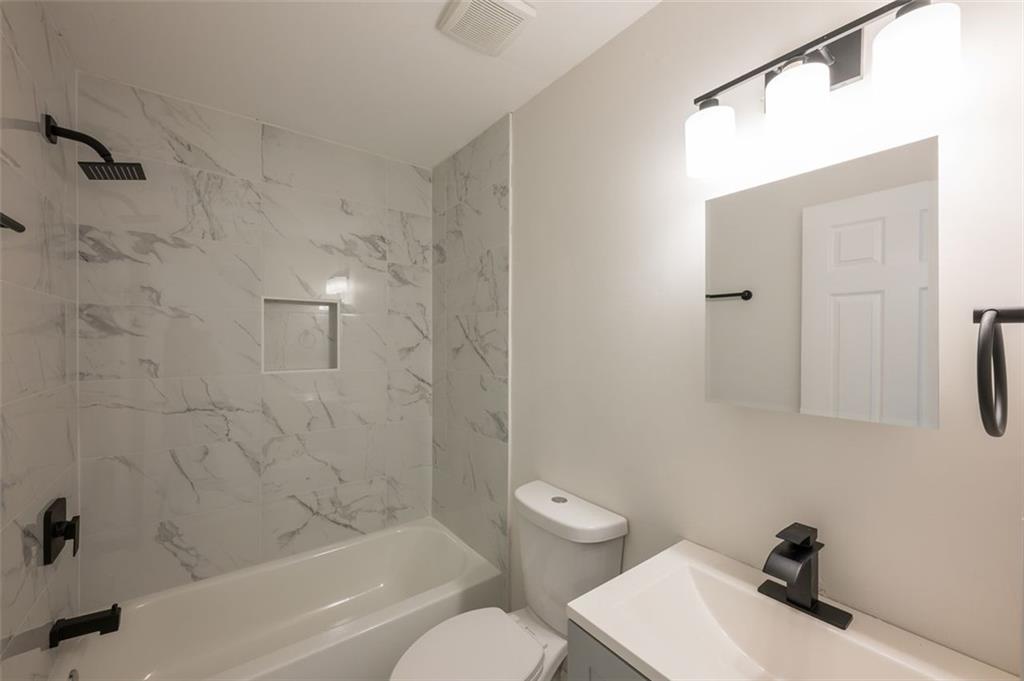 2027 Lois Place Northwest, Unit A Atlanta, GA 30318 - Photo 21 of 23 a bathroom with a sink toilet and shower