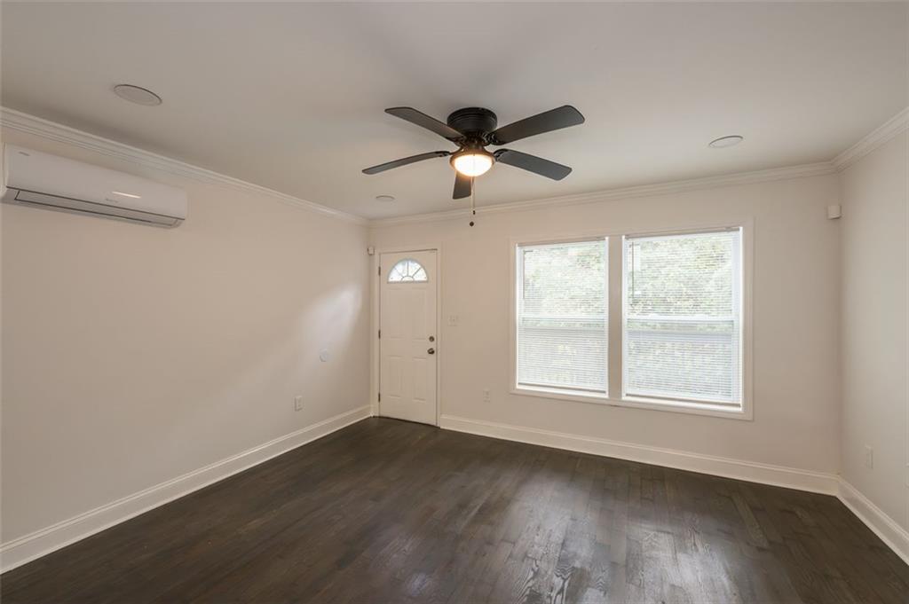 2027 Lois Place Northwest, Unit A Atlanta, GA 30318 - Photo 6 of 23 a view of an empty room with wooden floor and a window