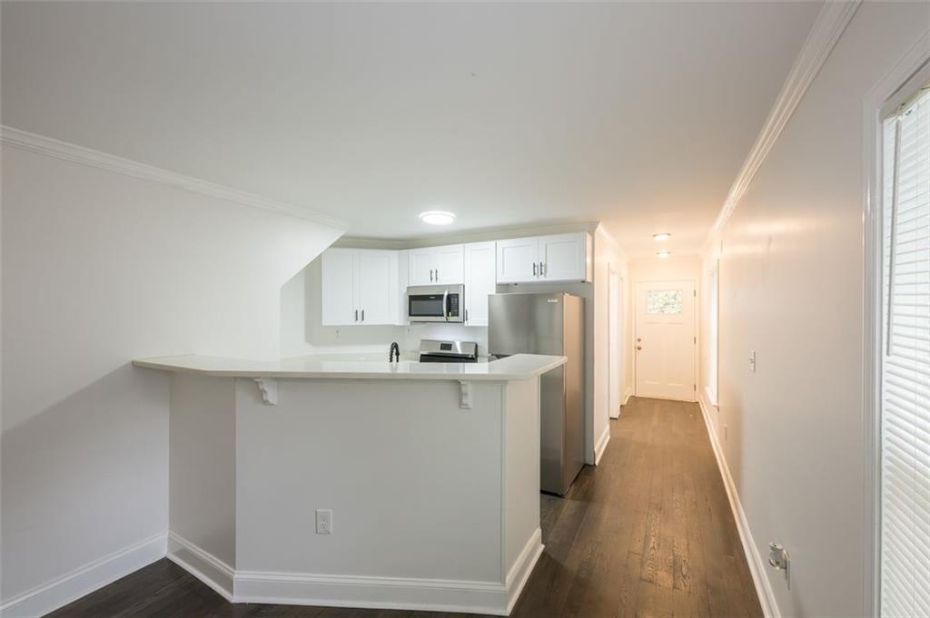 2027 Lois Place Northwest, Unit A Atlanta, GA 30318 - Photo 8 of 23 a kitchen with stainless steel appliances a sink stove and refrigerator