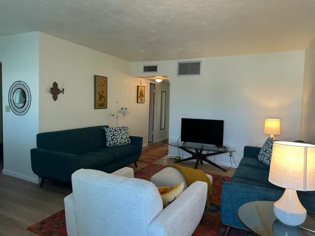 a living room with furniture and a rug