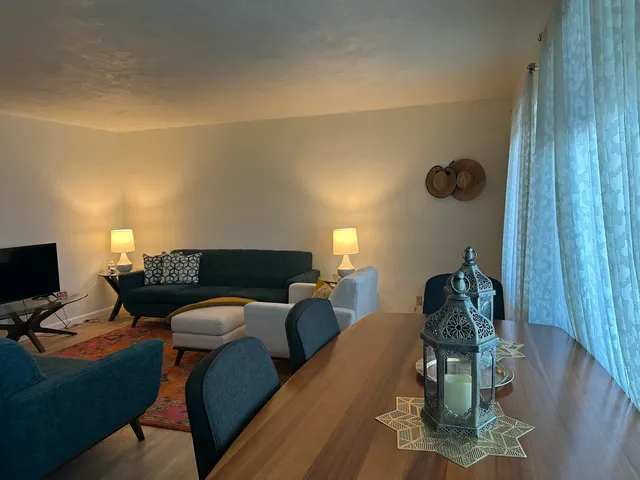 a view of a dining room with furniture and window
