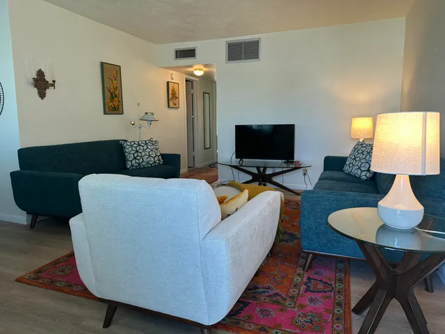 a living room with furniture and a large window