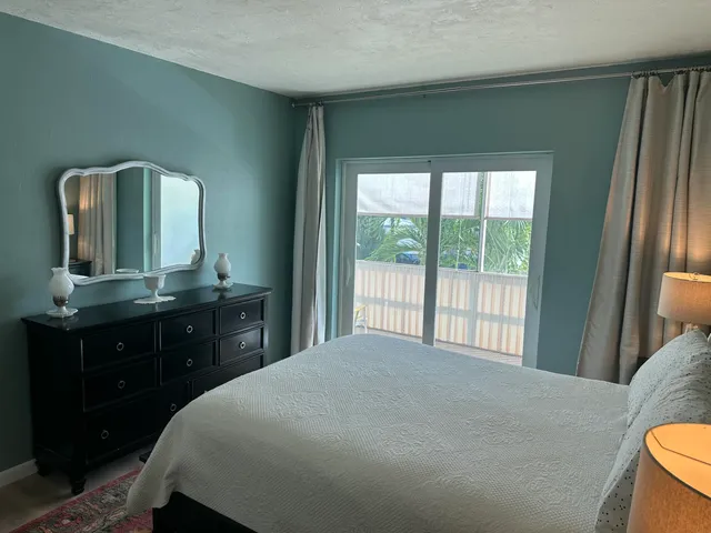 a bed sitting in a bedroom and painting on the wall