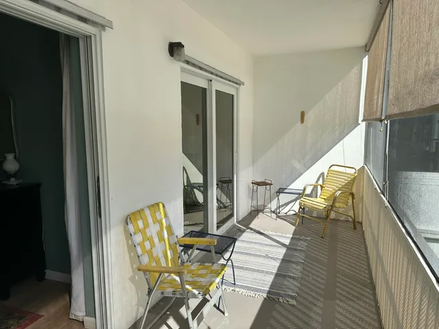 a view of a balcony with chair and table