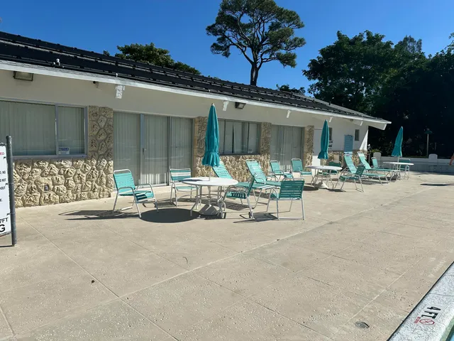 a view of building with cars parked in front of it