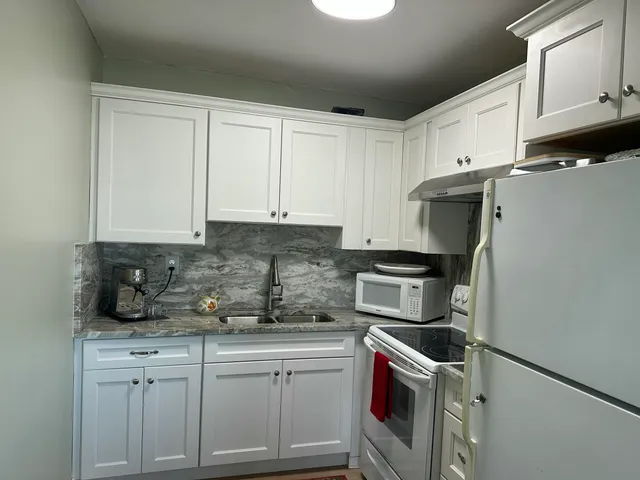 a kitchen with a sink and cabinets