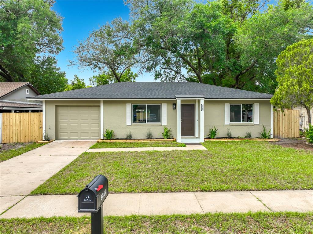 6848 Compass Court Orlando, FL 32810 - Photo 1 of 47 a front view of house with yard and green space