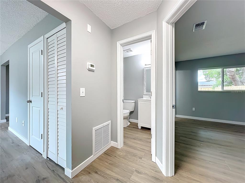 6848 Compass Court Orlando, FL 32810 - Photo 20 of 47 a view of a bathroom from a hallway