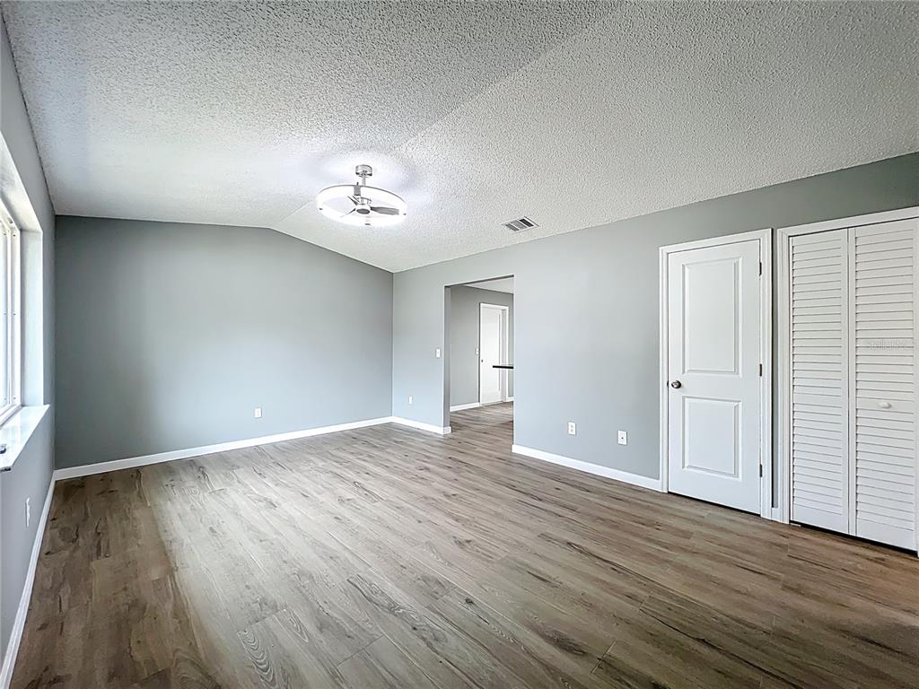 6848 Compass Court Orlando, FL 32810 - Photo 3 of 47 wooden floor in an empty room with a window