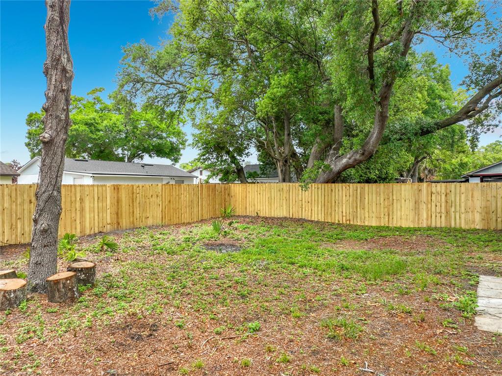 6848 Compass Court Orlando, FL 32810 - Photo 32 of 47 a view of a backyard with wooden fence
