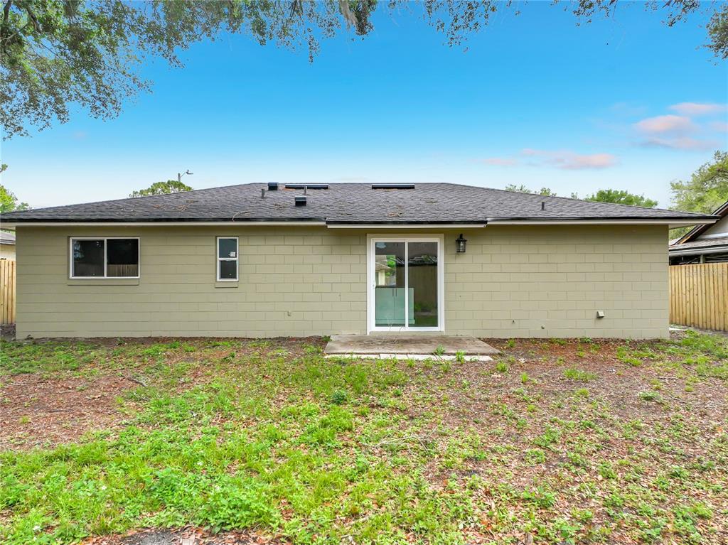 6848 Compass Court Orlando, FL 32810 - Photo 35 of 47 a view of a house with a backyard