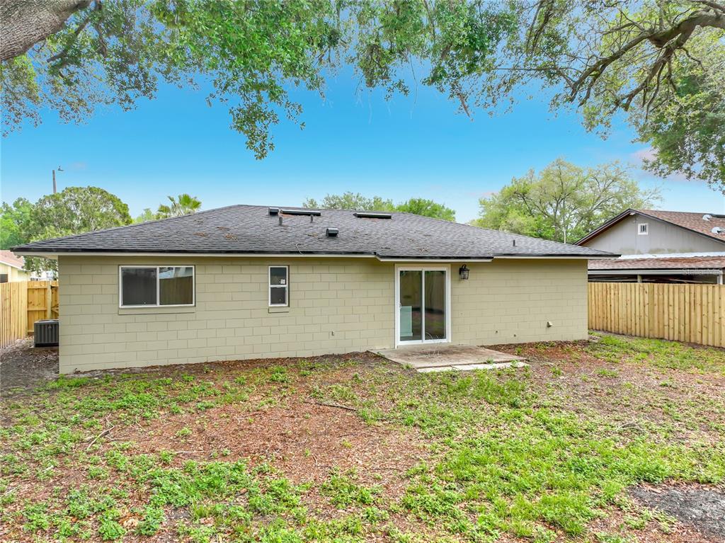6848 Compass Court Orlando, FL 32810 - Photo 36 of 47 front view of house with a yard