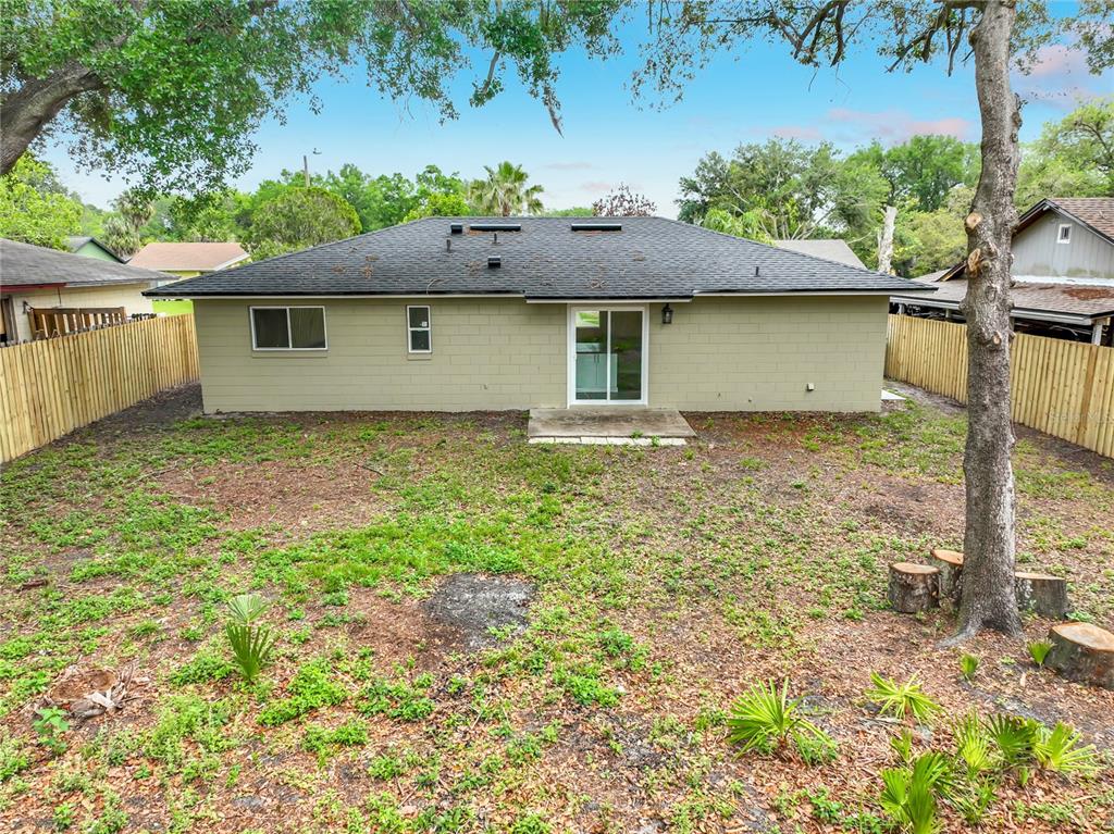 6848 Compass Court Orlando, FL 32810 - Photo 38 of 47 a front view of a house with a yard