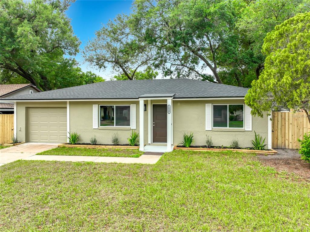6848 Compass Court Orlando, FL 32810 - Photo 43 of 47 front view of a house that has a big yard