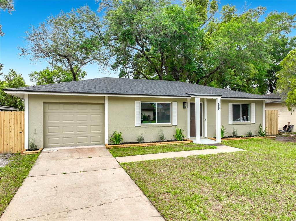 6848 Compass Court Orlando, FL 32810 - Photo 46 of 47 a front view of a house with a yard