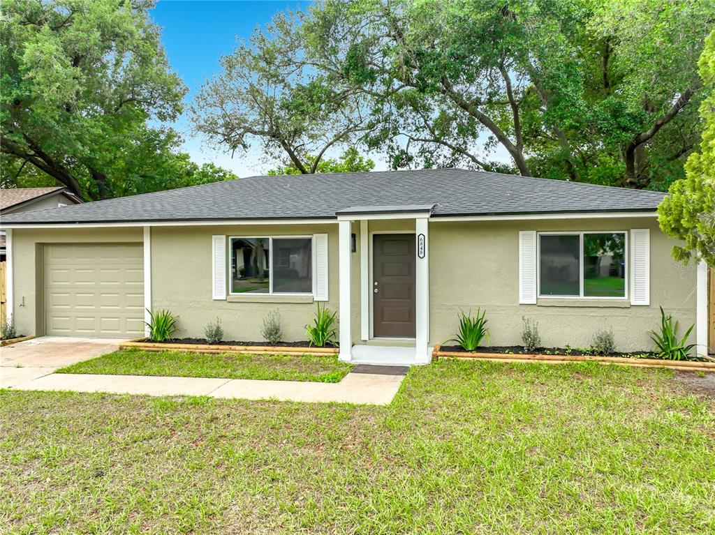 6848 Compass Court Orlando, FL 32810 - Photo 47 of 47 a front view of a house with a yard