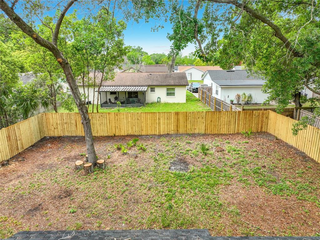 6848 Compass Court Orlando, FL 32810 - Photo 6 of 47 a front view of a house with a yard