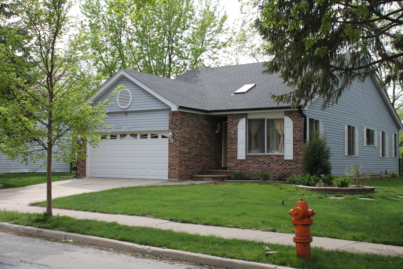 1925 Lisson Road Naperville, IL 60565 - Photo 1 of 18 a front view of a house with a garden and yard