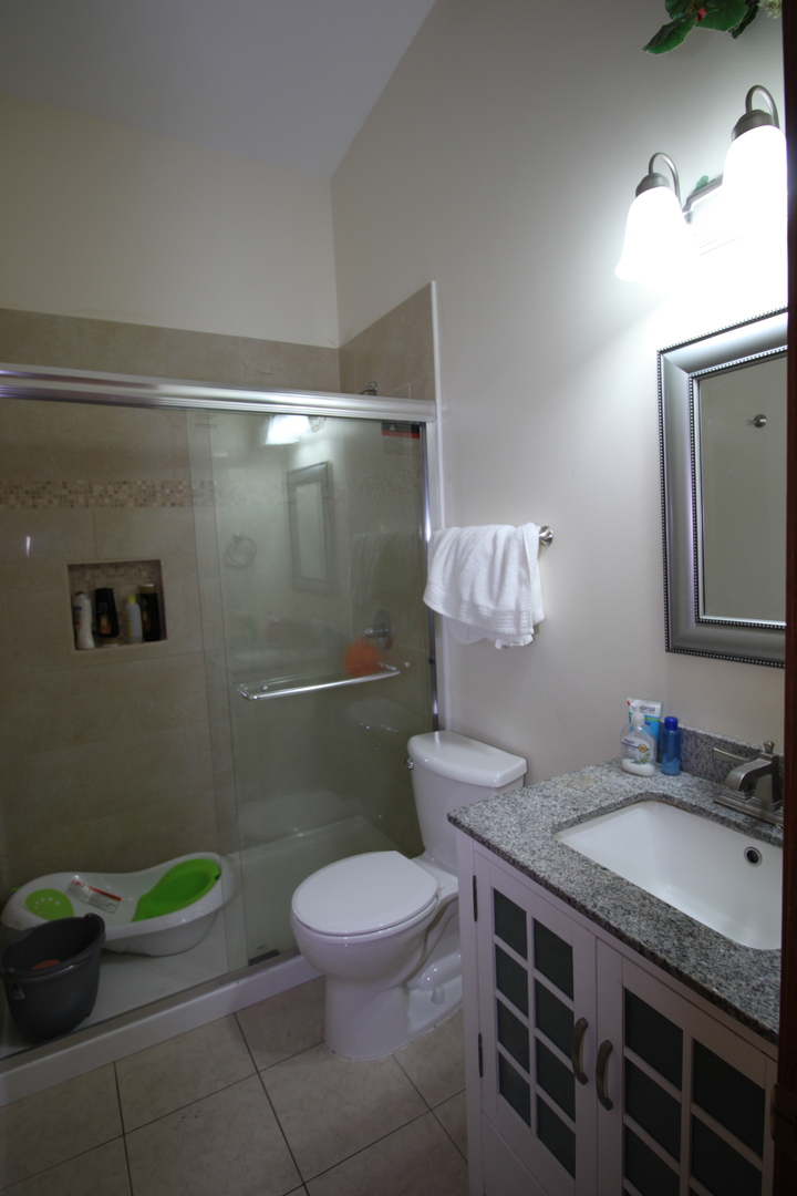 1925 Lisson Road Naperville, IL 60565 - Photo 9 of 18 a bathroom with a granite countertop toilet sink and mirror
