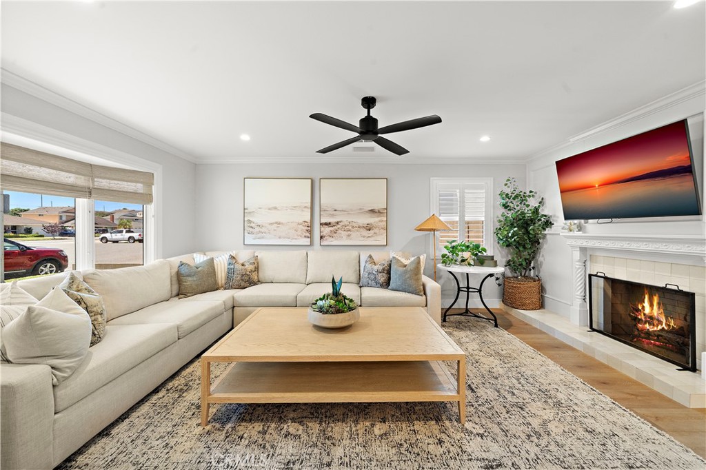 8741 La Roca Avenue Fountain Valley, CA 92708 - Photo 4 of 50 Beautiful formal living room with bay window, crown molding, fireplace, recessed lighting, and newer wide plank vinyl flooring